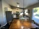 Kitchen featuring stainless steel appliances, white cabinets, and an adjacent dining table at 24809 N 41 Ave, Glendale, AZ 85310