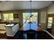 Dining area featuring a dark wood table and floors with a view to the backyard at 24809 N 41 Ave, Glendale, AZ 85310