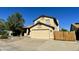 Exterior shot of tan home with a two-car garage and a wooden gate at 24809 N 41 Ave, Glendale, AZ 85310