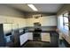 Kitchen featuring stainless steel appliances, white cabinetry, and dark countertops at 24809 N 41 Ave, Glendale, AZ 85310