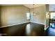 Spacious living room featuring dark wood floors and a modern light fixture at 24809 N 41 Ave, Glendale, AZ 85310