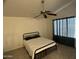 Main bedroom features a ceiling fan, a black metal bed frame, and dark curtains at 24809 N 41 Ave, Glendale, AZ 85310