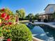 Sparkling private pool surrounded by vibrant flowers and manicured landscaping at 24809 N 41 Ave, Glendale, AZ 85310