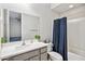 Bathroom featuring a shower with blue curtain, toilet, and sink with grey cabinets at 25451 N 164Th Dr, Surprise, AZ 85387