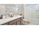 Bathroom featuring a shower with curtain, toilet, and double sink with grey cabinets at 25451 N 164Th Dr, Surprise, AZ 85387