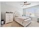 Calm bedroom featuring a tufted headboard bed, dresser, and natural light creating a relaxing ambiance at 25451 N 164Th Dr, Surprise, AZ 85387