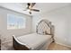 Bedroom features a upholstered headboard bed, carpet and large window with blinds at 25451 N 164Th Dr, Surprise, AZ 85387