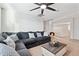 Relaxing living room with a large sectional sofa, ceiling fan, and loft overlook, ideal for lounging at 25451 N 164Th Dr, Surprise, AZ 85387