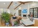 Bright living room features hardwood floors, wood beam ceiling, a fireplace, and comfortable seating at 3530 E Glenrosa Ave, Phoenix, AZ 85018