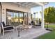 Inviting outdoor patio with a hanging chair, modern furniture, and a manicured lawn at 3530 E Glenrosa Ave, Phoenix, AZ 85018