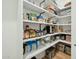 Walk-in pantry with open shelving offering ample storage space for food and kitchen essentials at 3530 E Glenrosa Ave, Phoenix, AZ 85018