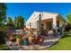 Charming backyard with a pool, lounge furniture, decorative pots, and lush greenery at 3890 S Star Canyon Dr, Gilbert, AZ 85297