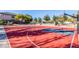 Community basketball court with red playing surface, basketball hoop, seating, and surrounding greenery at 3890 S Star Canyon Dr, Gilbert, AZ 85297