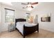 Cozy bedroom boasts a dark wood bed frame, two side tables, and natural light at 3890 S Star Canyon Dr, Gilbert, AZ 85297