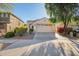 Charming single-story home featuring a two-car garage, desert landscaping, and a welcoming entryway at 3890 S Star Canyon Dr, Gilbert, AZ 85297