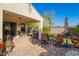 Covered patio features a dining area, grill, and comfortable seating overlooking the lush yard at 3890 S Star Canyon Dr, Gilbert, AZ 85297