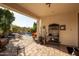 Covered patio with brick flooring and wrought iron decor, overlooking the refreshing backyard pool at 3890 S Star Canyon Dr, Gilbert, AZ 85297