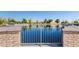 Scenic view of the community pond from behind a decorative fence, showcasing peaceful water and mature trees at 3890 S Star Canyon Dr, Gilbert, AZ 85297