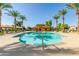 A scenic view of the community pool, surrounded by lush landscaping and palm trees, with covered lounge seating at 3890 S Star Canyon Dr, Gilbert, AZ 85297