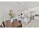 Dining area with wood table and chairs adjacent to modern open kitchen at 42038 N Moss Springs Rd, Anthem, AZ 85086