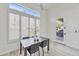 Bright dining area features large windows, wood table and four black chairs at 42038 N Moss Springs Rd, Anthem, AZ 85086