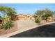 Southwest-style home featuring mature desert landscaping and spacious three car garage at 42038 N Moss Springs Rd, Anthem, AZ 85086