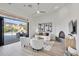 Bright living room with modern fireplace and doors leading to a luxury pool area at 42038 N Moss Springs Rd, Anthem, AZ 85086