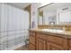 Well-maintained bathroom featuring a shower-tub combo, tile countertop, and wood vanity at 4718 E Mossman Rd, Phoenix, AZ 85050