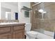 Bathroom with a tiled shower-tub combo, spacious vanity, and a comfortable toilet at 4718 E Mossman Rd, Phoenix, AZ 85050