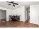 Traditional dining room featuring wood-look flooring, a dark wood table, and modern ceiling fan at 5735 E Mcdowell E Rd # 213, Mesa, AZ 85215