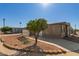 Tan home with citrus tree in the yard and a long paved driveway at 5735 E Mcdowell E Rd # 213, Mesa, AZ 85215