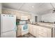 Kitchen with white appliances and light wood cabinetry at 5735 E Mcdowell E Rd # 213, Mesa, AZ 85215