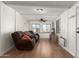 Living room with brown leather reclining sofa, ceiling fan and wood flooring at 5735 E Mcdowell E Rd # 213, Mesa, AZ 85215