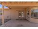 A covered outdoor patio with double doors and a concrete floor offers a relaxing retreat at 6534 S Marilyn Ann Dr, Tempe, AZ 85283