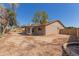 A spacious backyard featuring a brick home with a covered patio and desert landscaping at 6534 S Marilyn Ann Dr, Tempe, AZ 85283