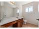 Bathroom featuring wood vanity, countertop and mirror with bright lighting at 6534 S Marilyn Ann Dr, Tempe, AZ 85283