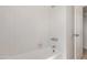 Bright white bathtub with white tiling and metal fixtures in the bathroom at 6534 S Marilyn Ann Dr, Tempe, AZ 85283