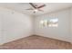 Bedroom with a ceiling fan, window and neutral colored walls and carpet at 6534 S Marilyn Ann Dr, Tempe, AZ 85283