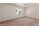 Well-lit main bedroom with a ceiling fan and neutral carpeting at 6534 S Marilyn Ann Dr, Tempe, AZ 85283