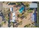 Aerial view showcases the beautiful house with a terracotta roof, a stunning pool, putting green, and a basketball court at 6915 E Gary Rd, Scottsdale, AZ 85254