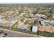 Expansive aerial view of a desert home with a pool, a putting green, and a basketball court surrounded by mature trees at 6915 E Gary Rd, Scottsdale, AZ 85254