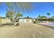 Expansive backyard featuring a large metal shop, gravel landscaping, and desert vegetation at 6915 E Gary Rd, Scottsdale, AZ 85254