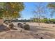 Expansive backyard featuring desert landscaping, mature trees, a basketball court, and ample space for recreation at 6915 E Gary Rd, Scottsdale, AZ 85254