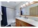 Bathroom featuring a light wooden vanity and a shower-over-tub with white subway tile at 6915 E Gary Rd, Scottsdale, AZ 85254