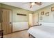 bedroom featuring green walls, a wooden bed, white carpet and molding, and multiple door access at 6915 E Gary Rd, Scottsdale, AZ 85254