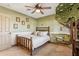 bedroom with a decorative tree mural, a wooden bed frame, and neutral carpet flooring at 6915 E Gary Rd, Scottsdale, AZ 85254