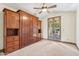 Bright bedroom featuring a large built-in Murphy bed and access to the outdoors through French doors at 6915 E Gary Rd, Scottsdale, AZ 85254