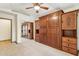 Bedroom with full Murphy bed, ceiling fan, hardwood floors, and large closet with mirrored doors at 6915 E Gary Rd, Scottsdale, AZ 85254