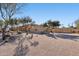 Attractive home with desert landscaping featuring mature trees and backyard privacy wall at 6915 E Gary Rd, Scottsdale, AZ 85254