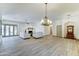 Expansive living room with fireplace, wood-look flooring, elegant lighting and seamless flow at 6915 E Gary Rd, Scottsdale, AZ 85254